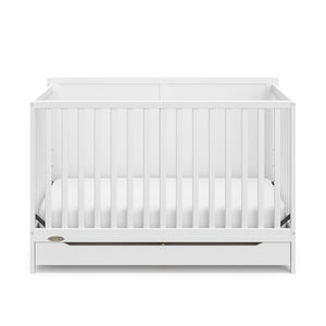 front view of white crib with drawer