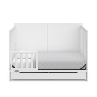 white crib with drawer in toddler bed conversion with one toddler safety guardrail