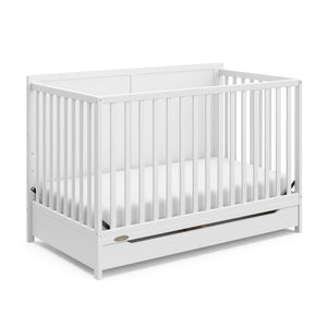 white crib with drawer angled view