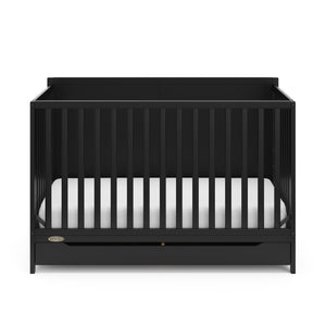 front view of black crib with drawer