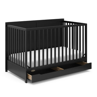 black crib with open drawer