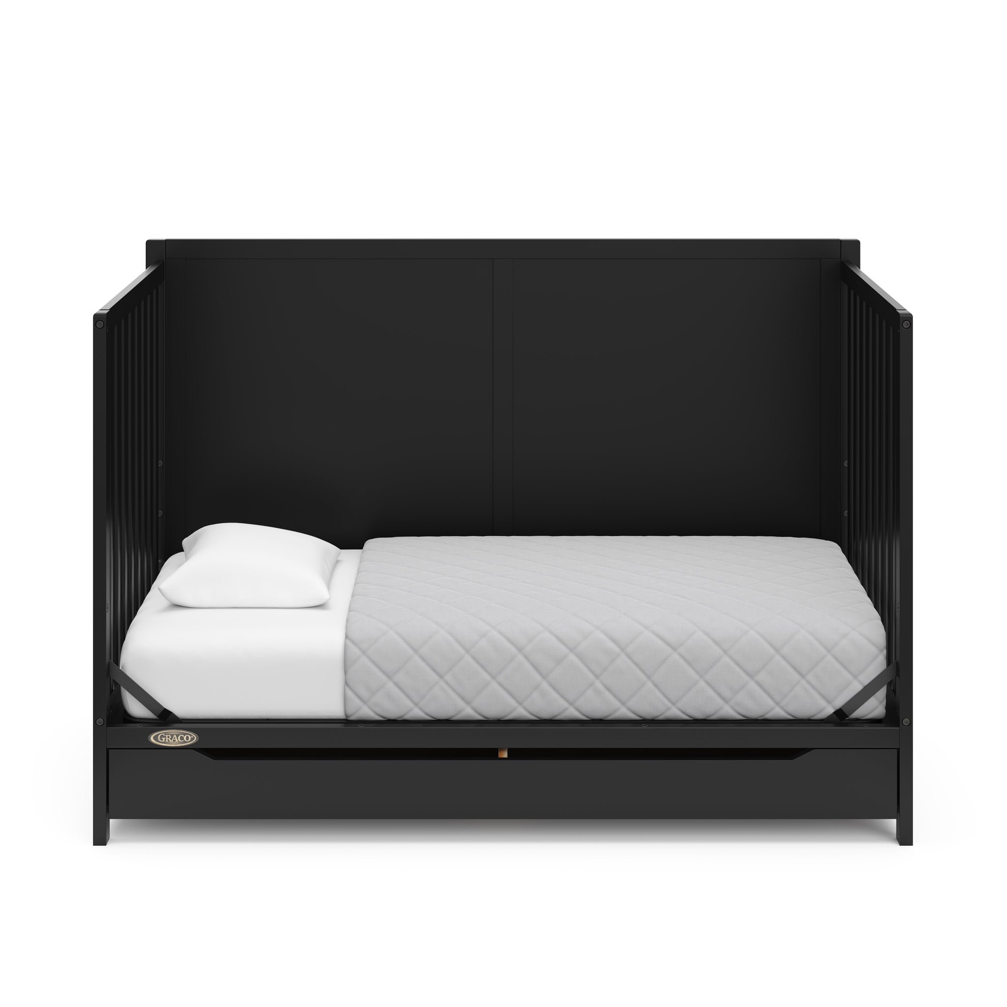 black crib with drawer in a toddler bed conversion