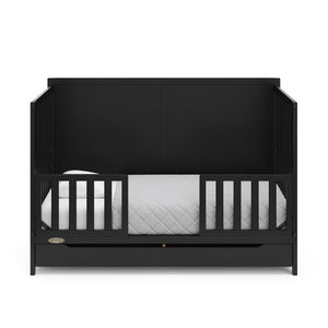 black crib with drawer in toddler bed with two toddler safety guardrail