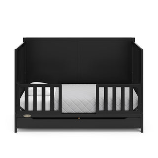 black crib with drawer in toddler bed with two toddler safety guardrail