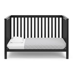 Black crib in toddler bed conversion