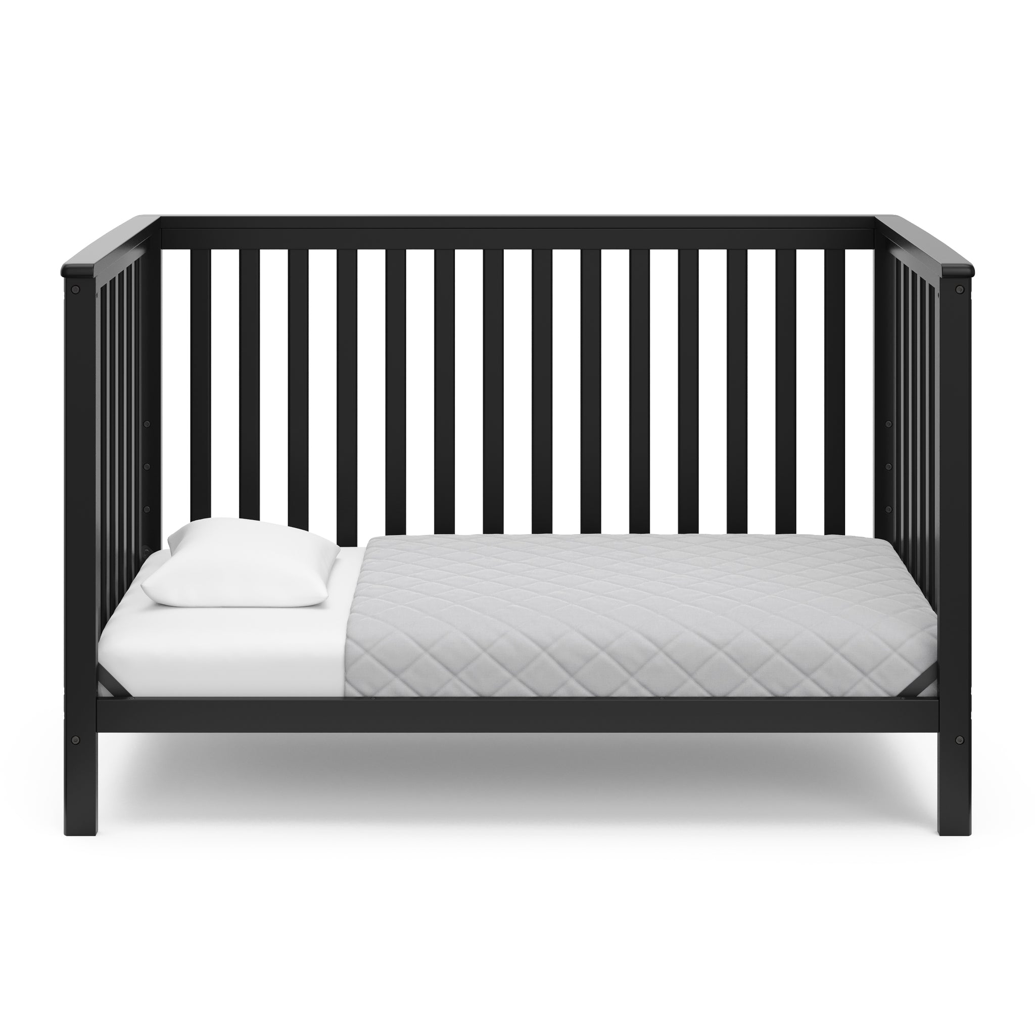 Black crib in toddler bed conversion