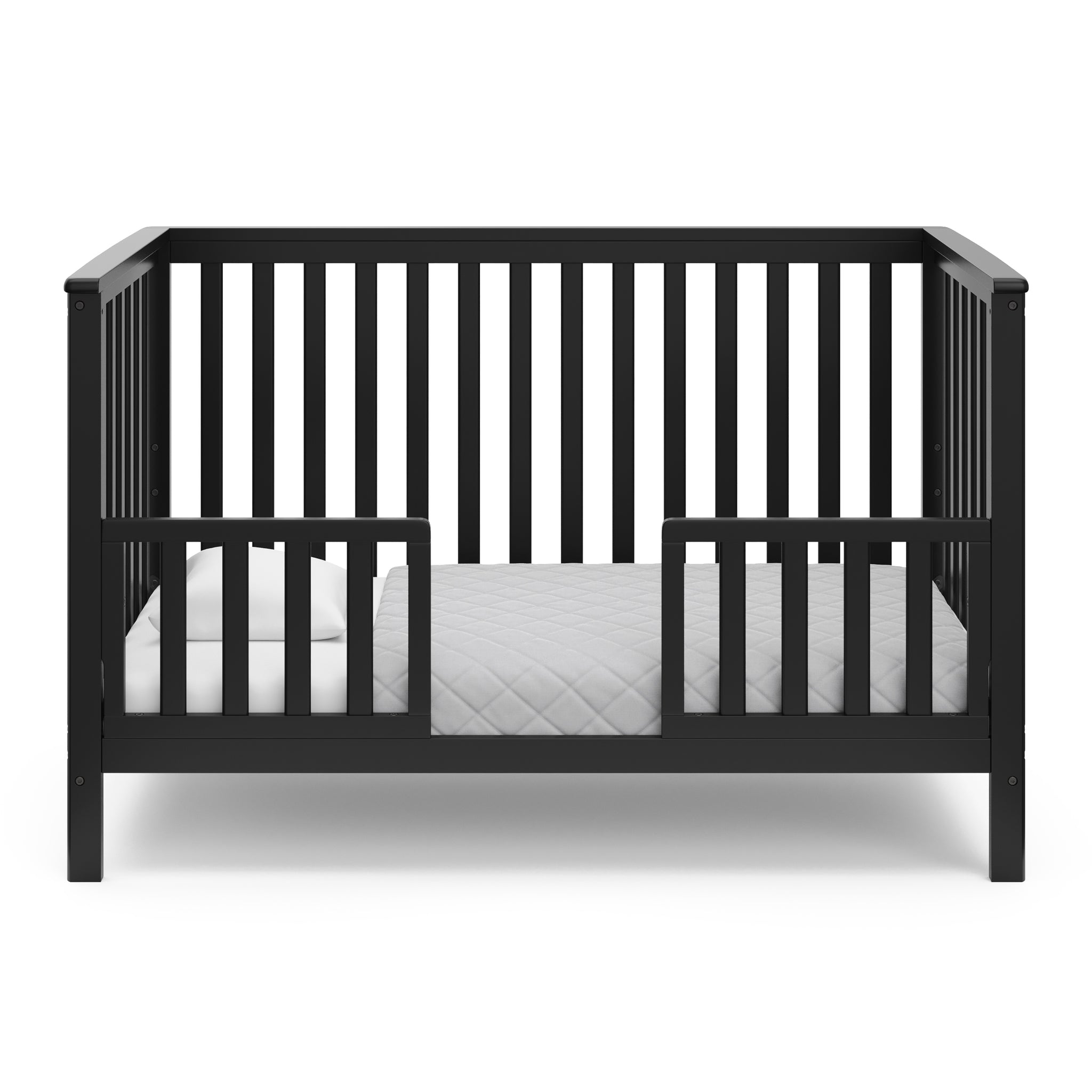 Black crib in toddler bed conversion with two safety guardrails