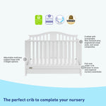White crib with drawer features graphic