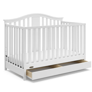 White crib with open drawer angled