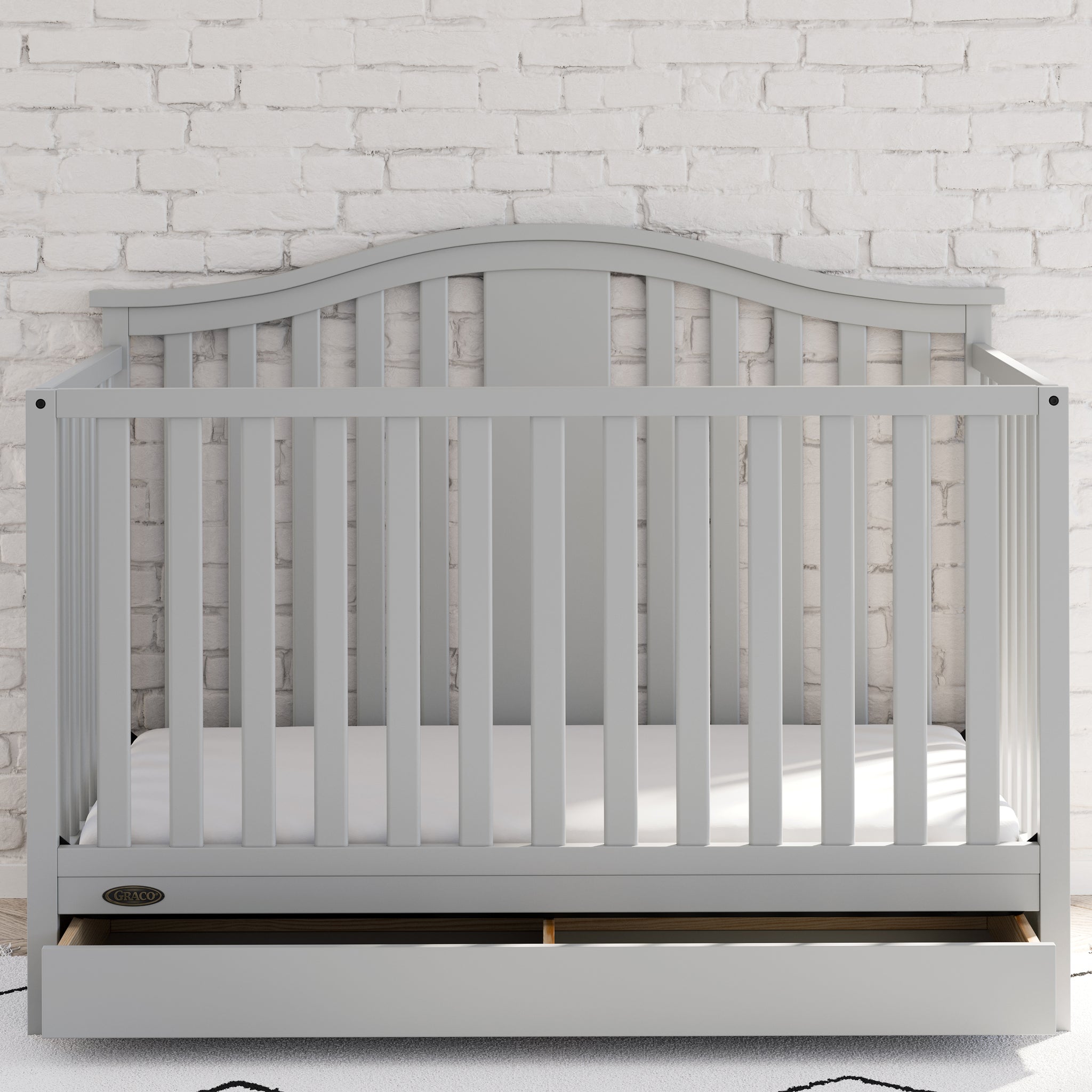 Pebble gray crib with drawer in nursery