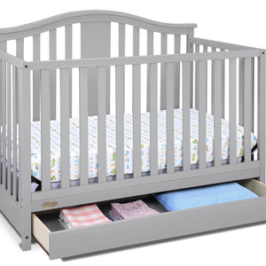 Pebble gray crib with open drawer angled