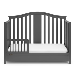 gray crib with drawer in toddler bed conversion with one safety guardrail