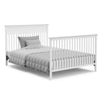 White crib in full-size bed with headboard and footboard conversion