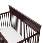 Close-up view of espresso crib's headboard