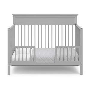 pebble gray crib in toddler bed conversion with two safety guardrails