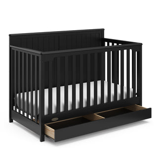 black crib with open drawer