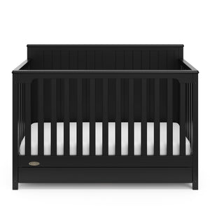 front view of black crib with drawer