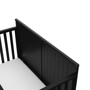 close-up view of black crib's headboard