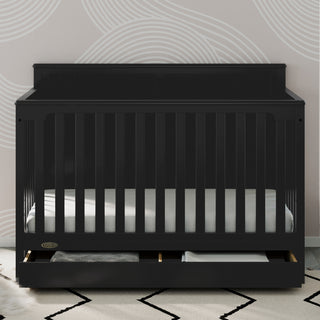 black crib with drawer in nursery