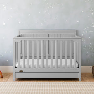 pebble gray crib with drawer in nursery