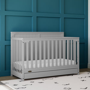 pebble gray crib with drawer in nursery