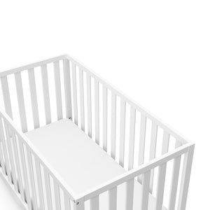 Close-up view of white crib's headboard