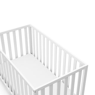 Close-up view of white crib's headboard