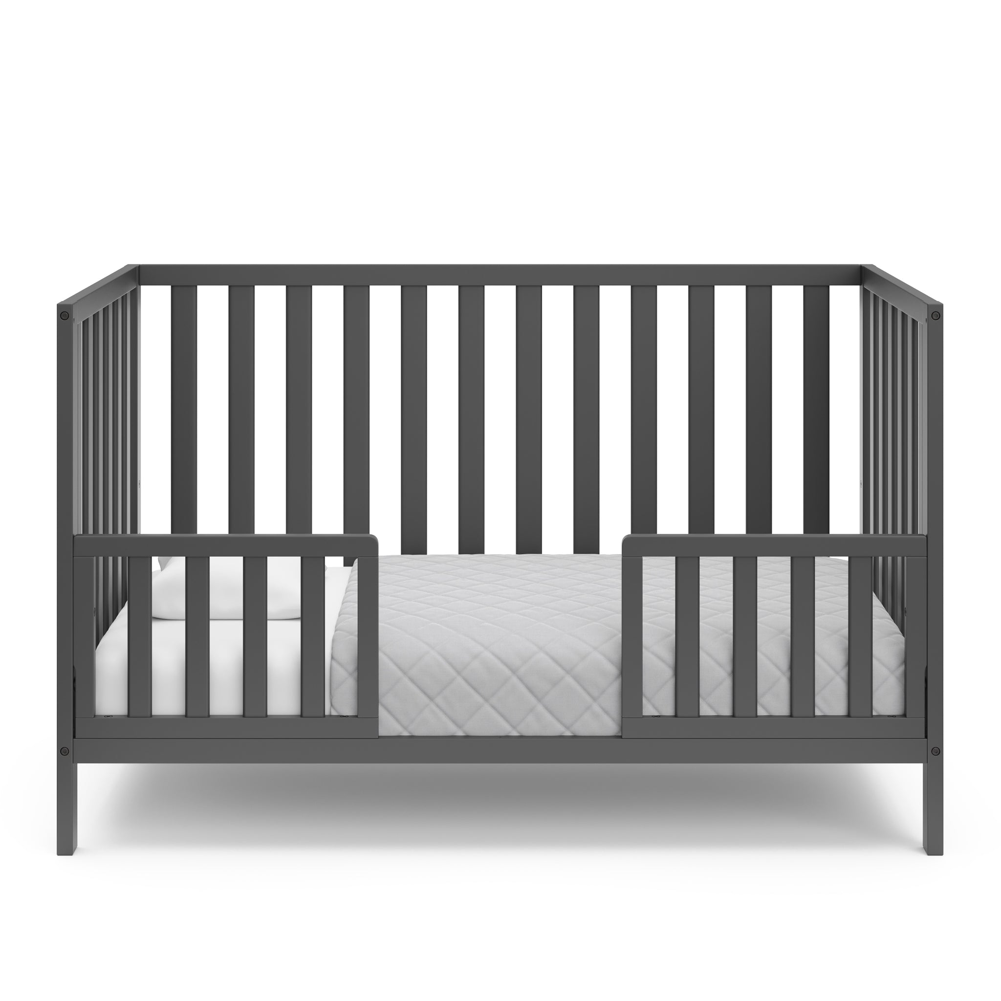 gray crib in toddler bed conversion with two safety guardrails