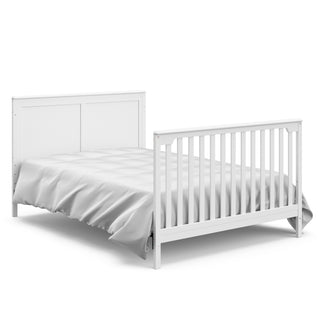 White crib in full-size bed with headboard and footboard conversion