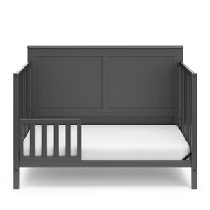 gray in toddler bed conversion with one safety guardrail