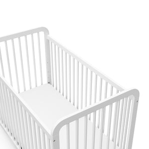 Close-up view of white crib's headboard 