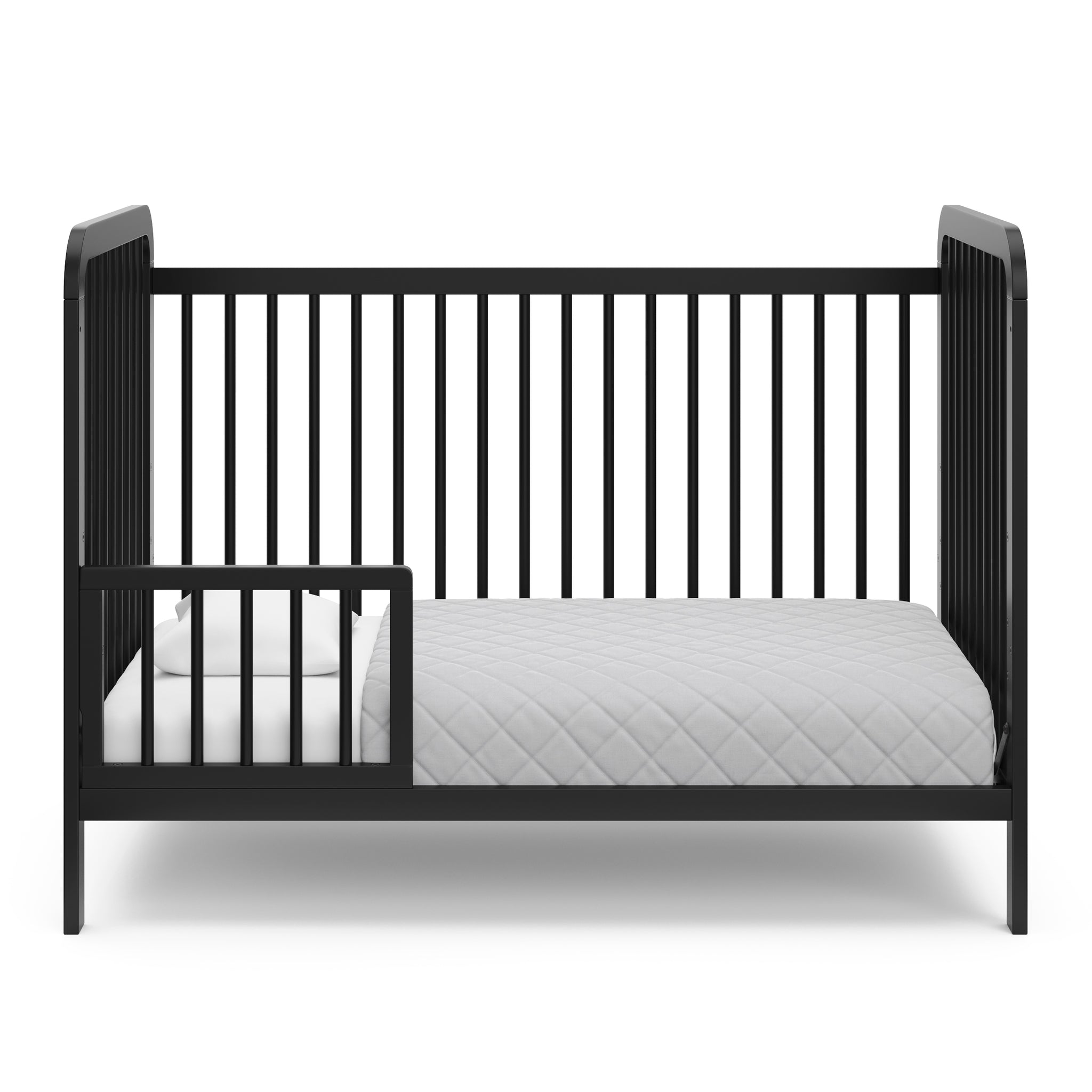 Black crib in toddler bed conversion with one safety guardrail 