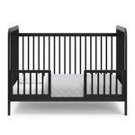 Black crib in toddler bed conversion with two safety guardrails 