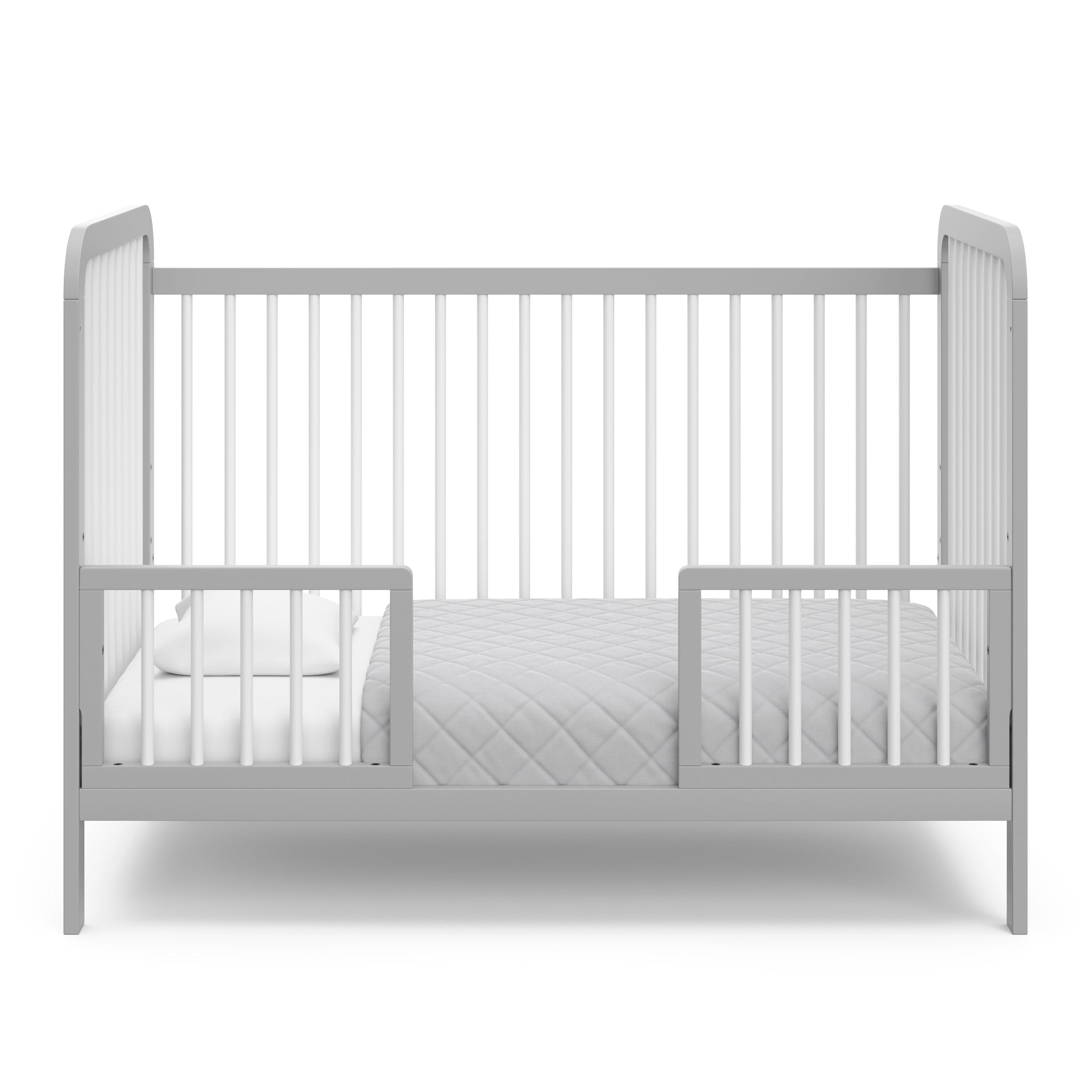 White crib with pebble gray in toddler bed conversion with two safety guardrails 