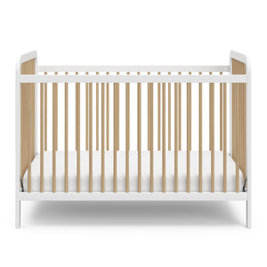 Front view of white crib with driftwood 