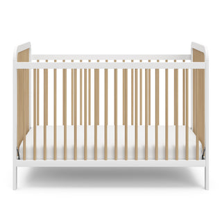 Front view of white crib with driftwood 