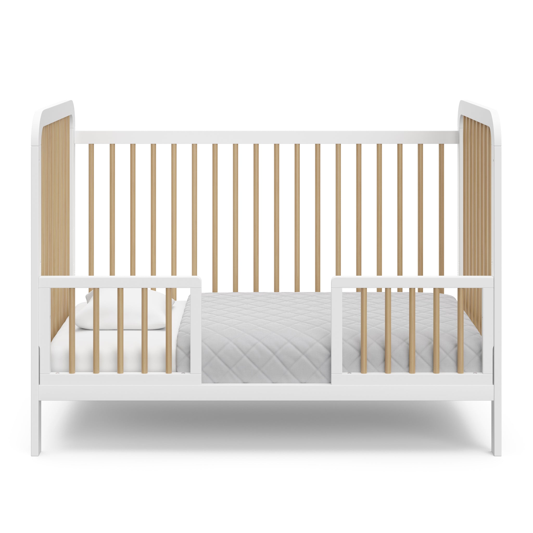 White crib with driftwood in toddler bed conversion with two safety guardrails 