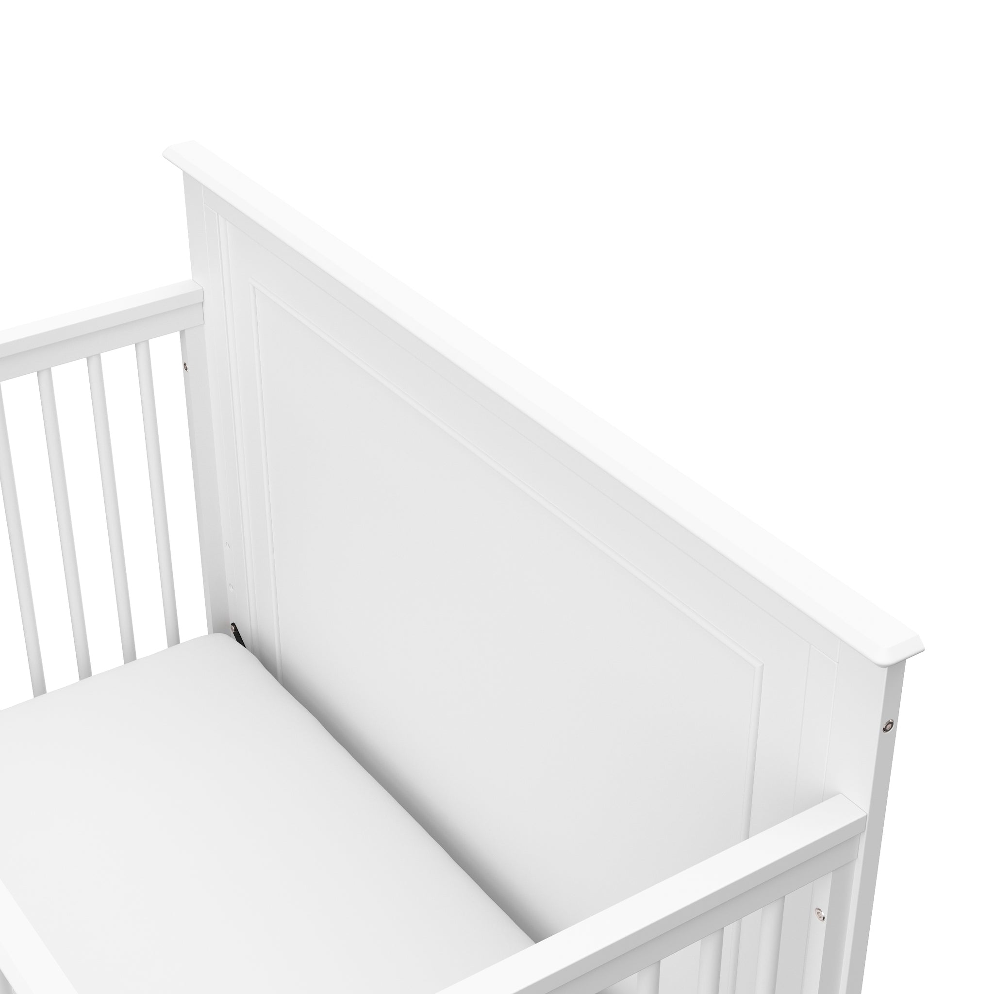 Close-up view of white crib's headboard 