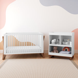 white crib with driftwood in nursery