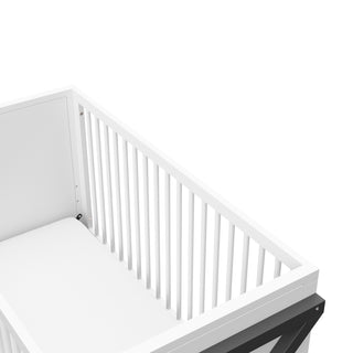 Close-up view of white with gray crib's headboard