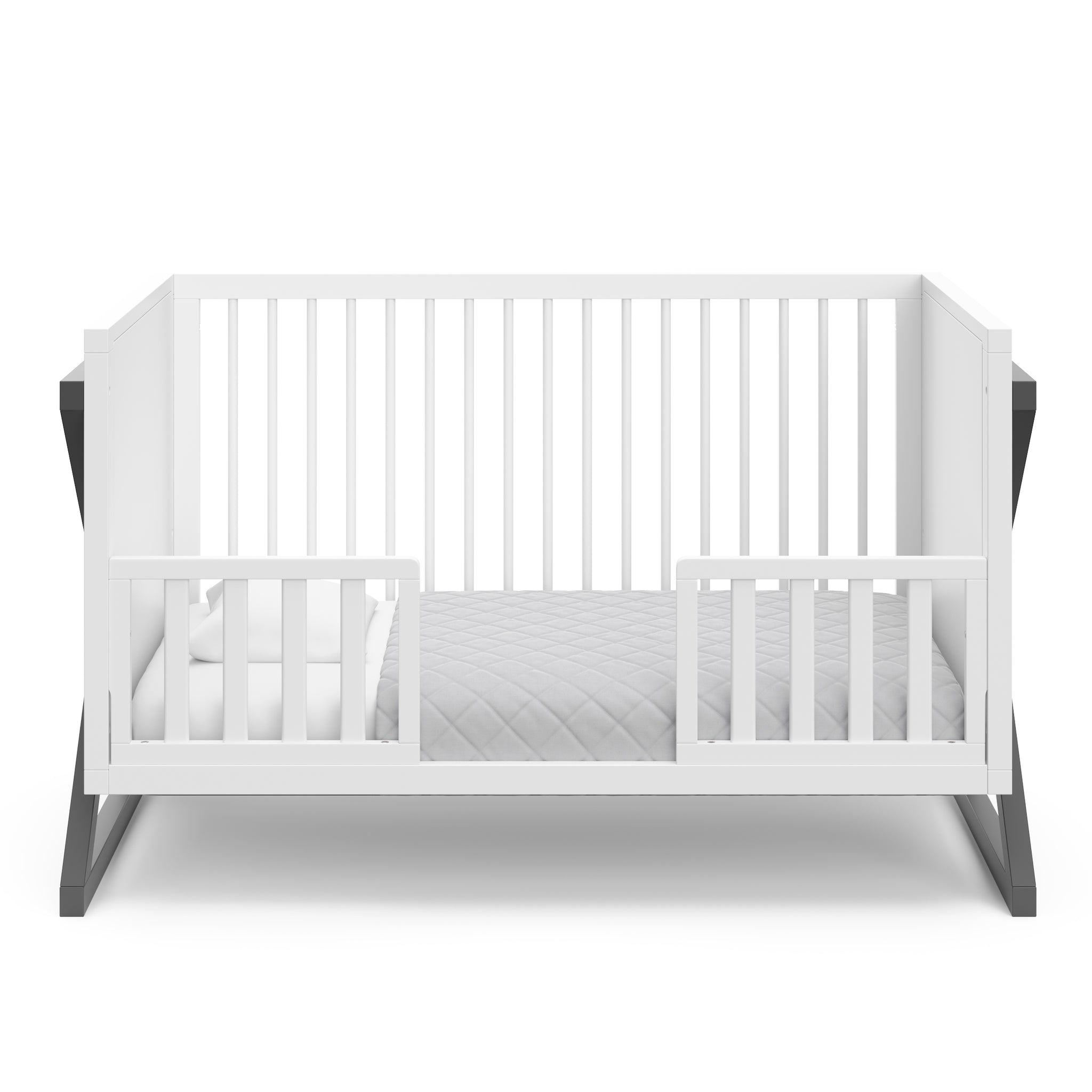 white with gray crib in toddler bed conversion with two safety guardrails