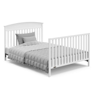 White crib in full-size bed with headboard and footboard conversion