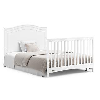 White crib in full-size bed with headboard and footboard conversion