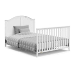 White crib in full-size bed with headboard and footboard conversion