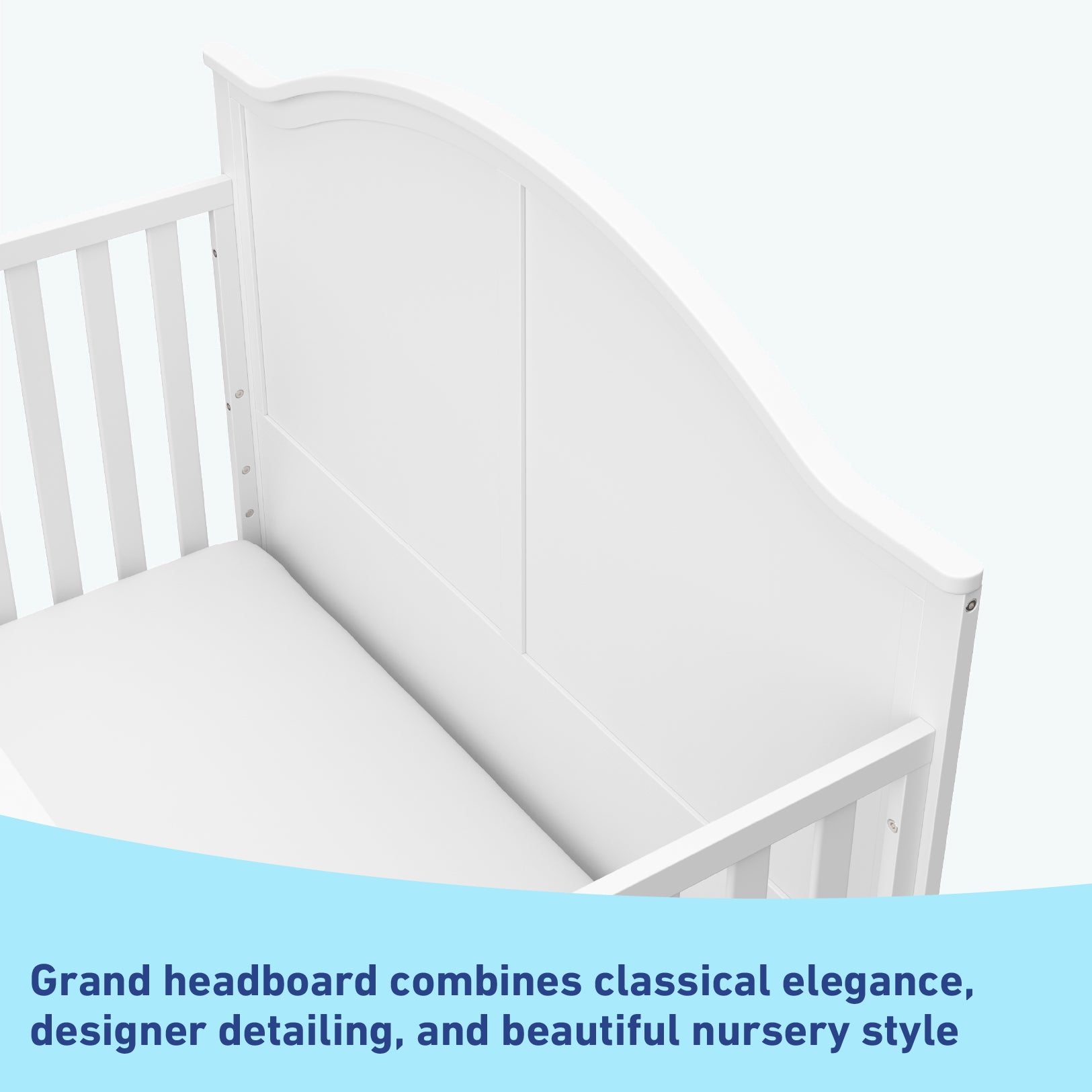 Close-up view of white crib's headboard graphic