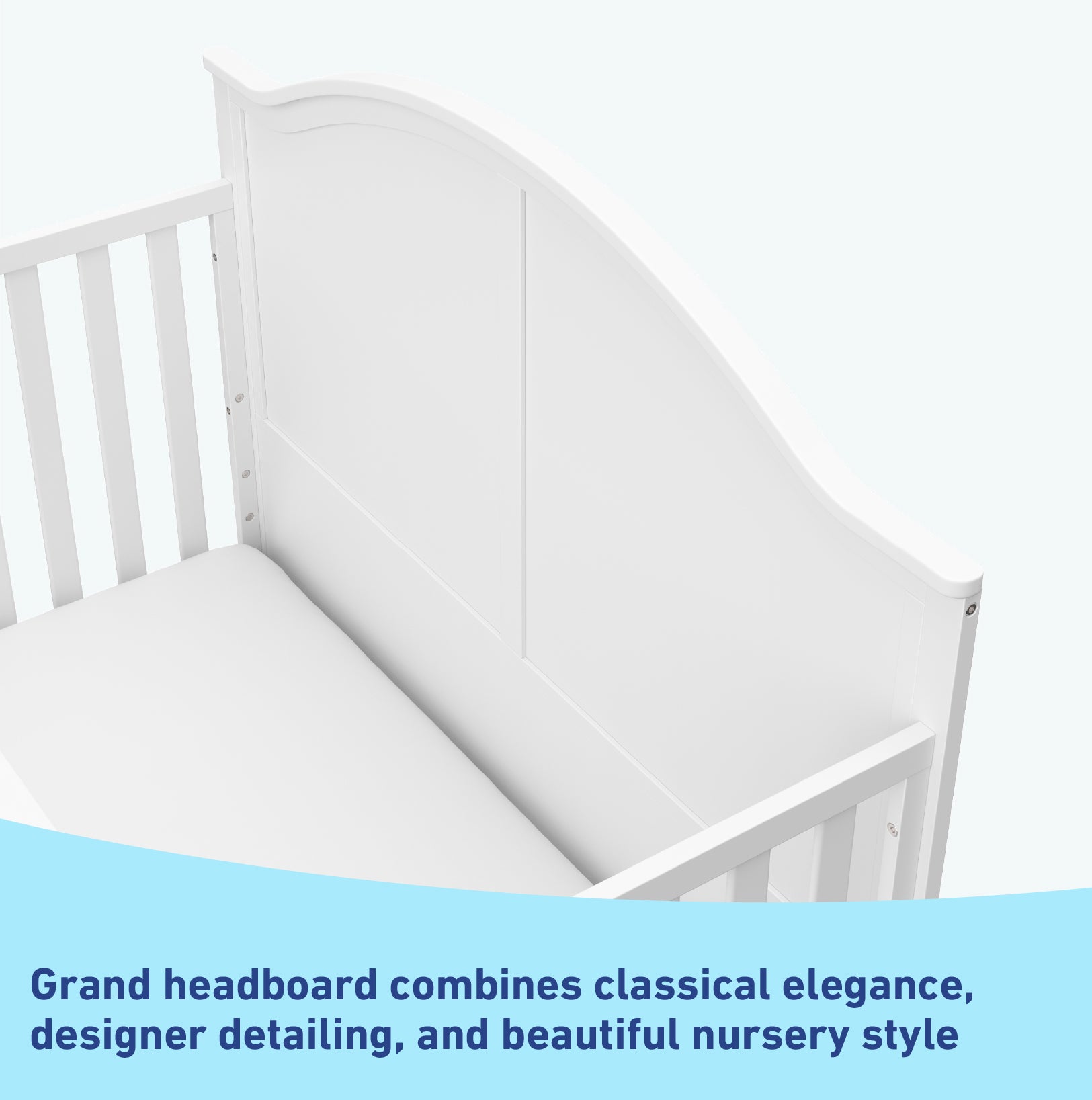 Close-up view of white crib's headboard graphic