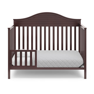 espresso in toddler bed conversion with one safety guardrail