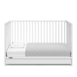 White crib with drawer in toddler bed conversion