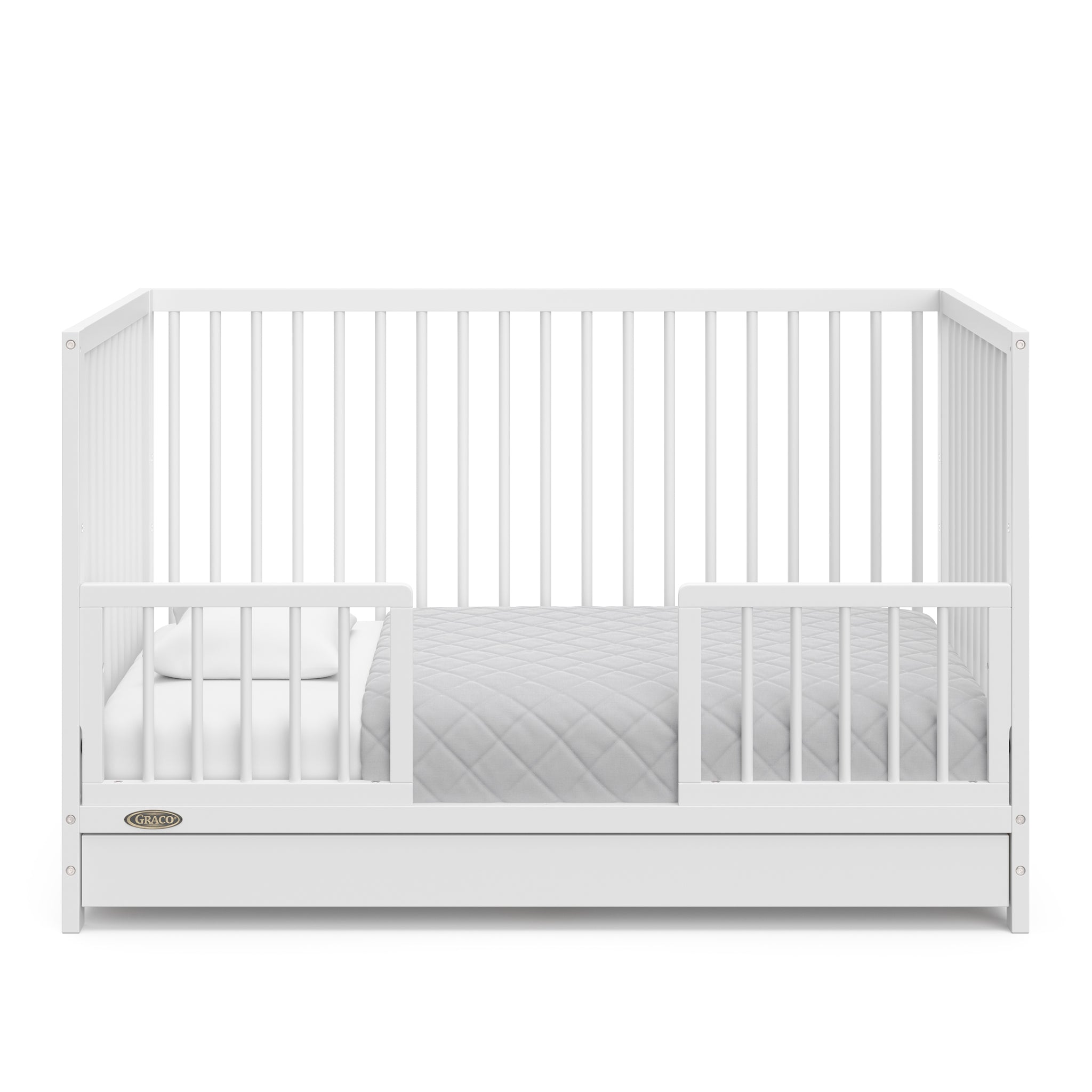 White crib with drawer in toddler bed conversion with two safety guardrails