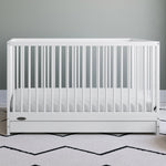 White crib with drawer in nursery